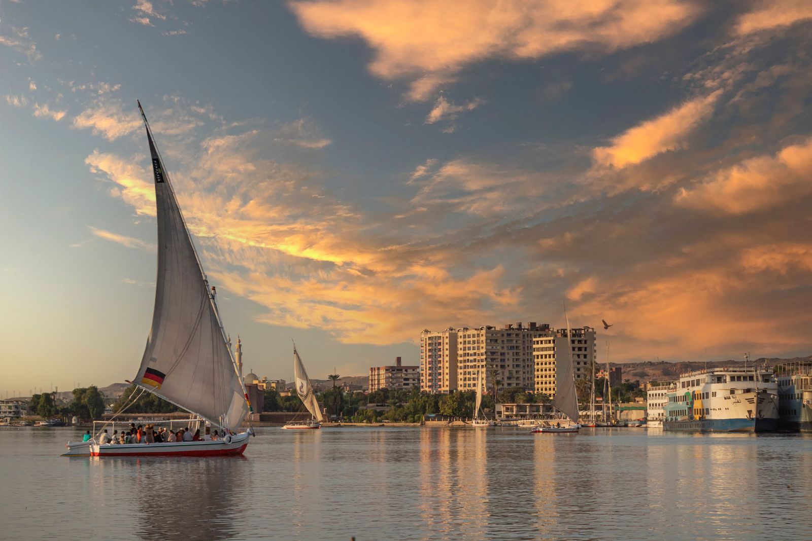 Felucca sailing the Nile at sunset, a classic river cruise vs land tour decision in Egypt